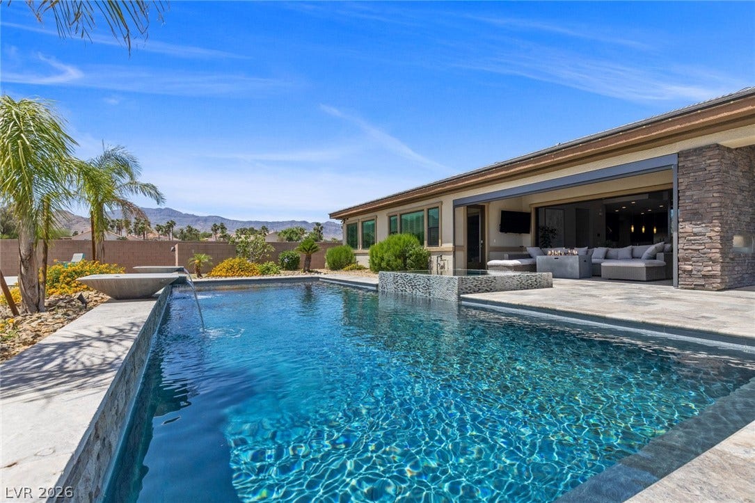 9841 W El Campo Grande Avenue, Las Vegas, NV 89149 A tranquil oasis awaits with a pristine pool and a stylish patio, perfect for enjoying serene mountain vistas.