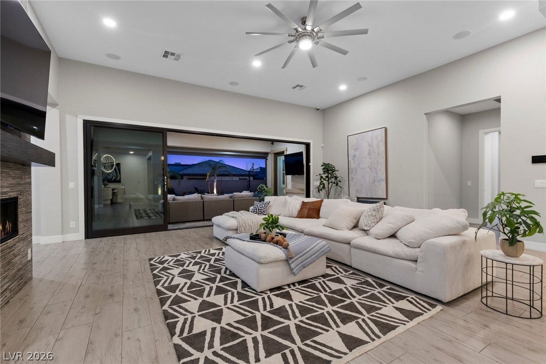 9841 W El Campo Grande Avenue, Las Vegas, NV 89149 An inviting gathering space features an open floorplan with light wood flooring and seamless access to the outdoors.