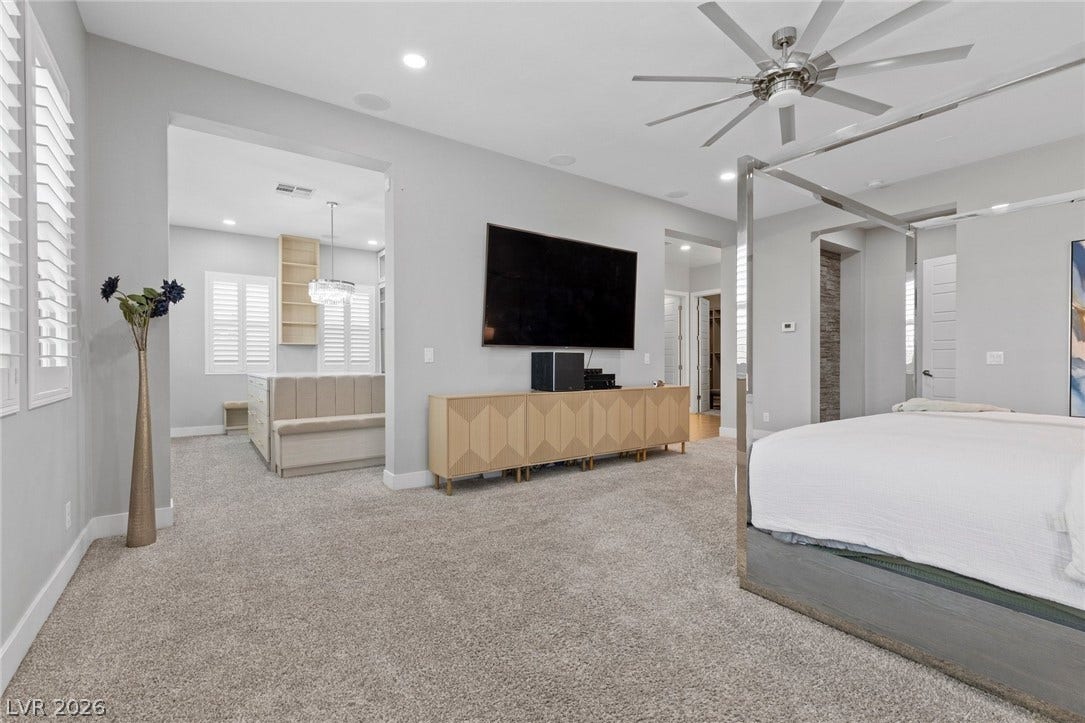 9841 W El Campo Grande Avenue, Las Vegas, NV 89149 Relax in this well-appointed bedroom featuring a ceiling fan and plush carpeting.