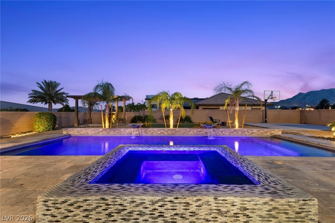 9841 W El Campo Grande Avenue, Las Vegas, NV 89149 An inviting backyard oasis offers a sparkling pool and spa, perfect for evening relaxation.