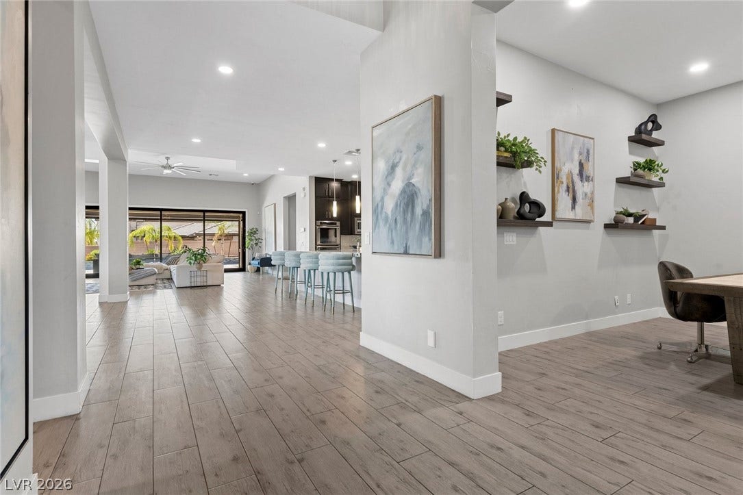 9841 W El Campo Grande Avenue, Las Vegas, NV 89149 Step into a generously proportioned interior showcasing elegant wood-look flooring and soaring ceilings.