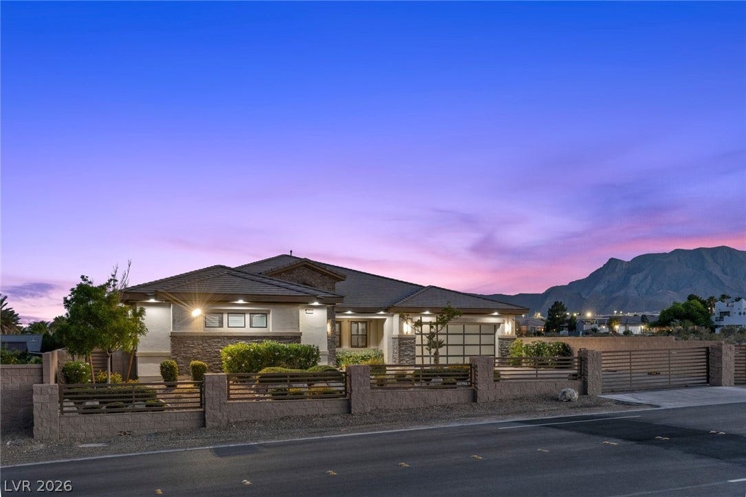 9841 W El Campo Grande Avenue, Las Vegas, NV 89149 A striking modern residence stands out against a beautiful twilight sky, offering mountain views.