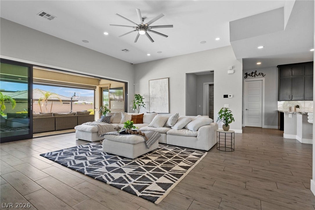 9841 W El Campo Grande Avenue, Las Vegas, NV 89149 Sliding glass doors seamlessly connect the great room to an inviting outdoor living space.