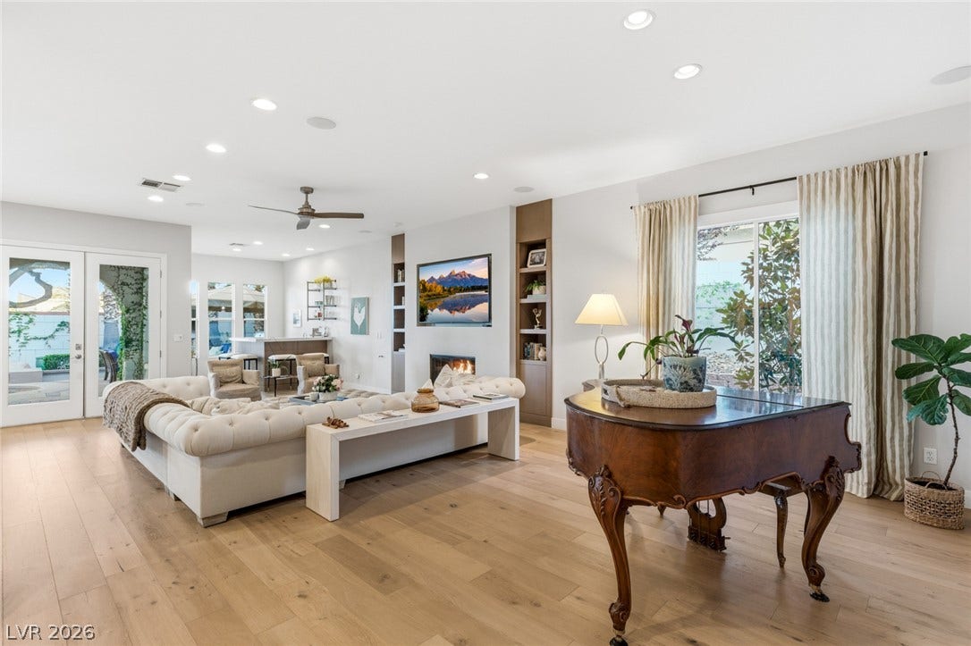 Gleaming hardwood floors and a modern fireplace elevate this expansive living space.