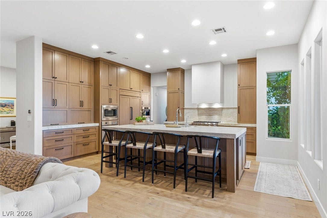 Gleaming hardwood floors and an expansive center island define this modern custom kitchen.