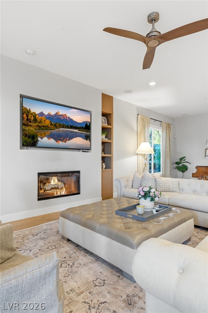 An inviting fireplace serves as the focal point of this warm living space with built-ins.