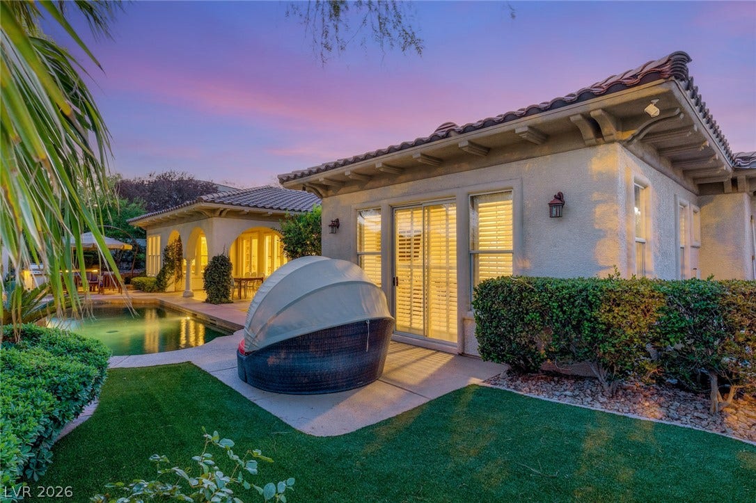 Mediterranean-inspired architecture frames a private backyard escape complete with an inviting swimming pool.
