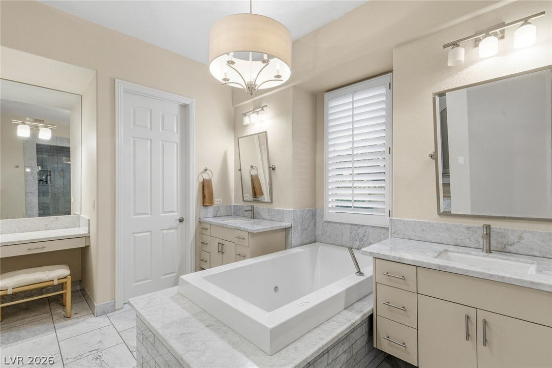 Fine marble surfaces and a built-in tub elevate this comfortable private bath.