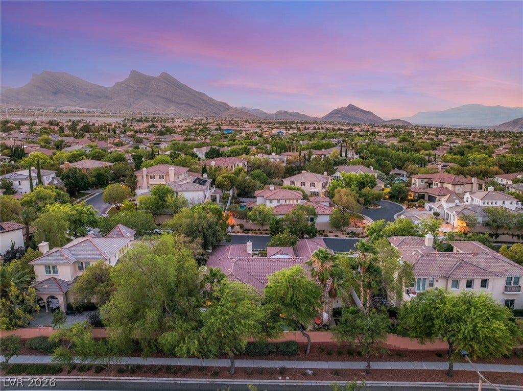 Majestic mountain ridges frame this peaceful suburban neighborhood of tile-roofed residences.