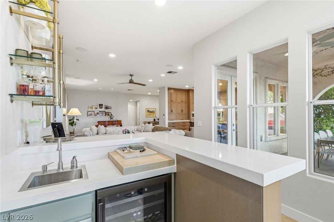 An inviting wet bar flows seamlessly into the bright, open-concept living area.