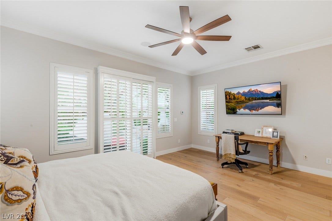 Gleaming hardwood floors and classic plantation shutters highlight this inviting space.