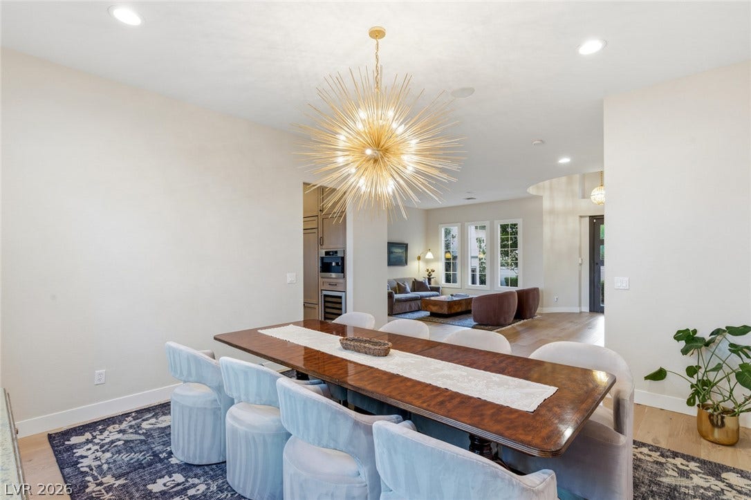 Gleaming hardwood floors and a spacious open layout flow seamlessly into the adjacent living space.