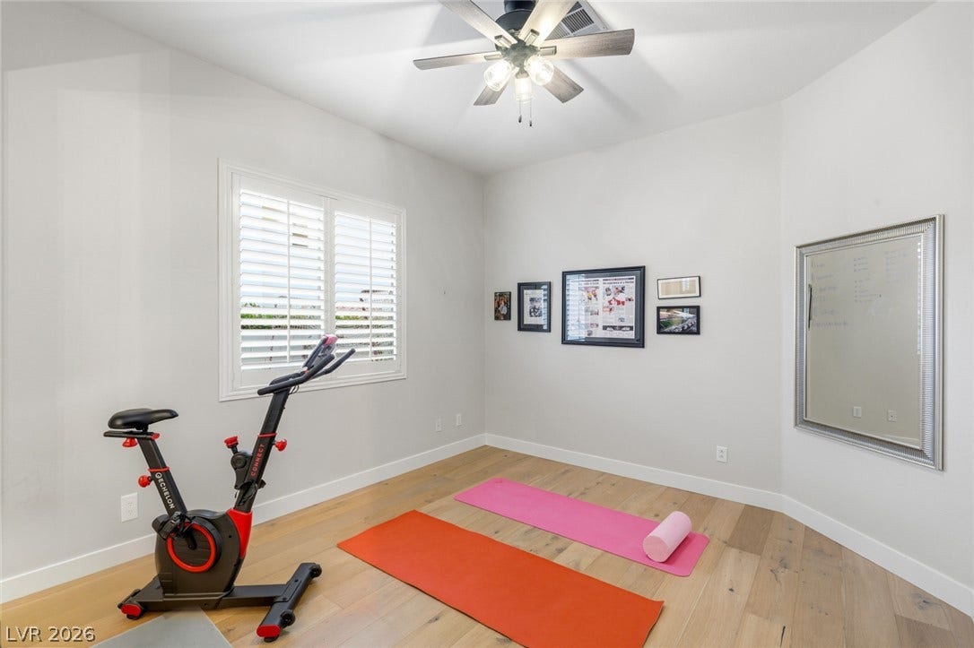 Gleaming hardwood floors and a bright window with shutters define this versatile bonus space.
