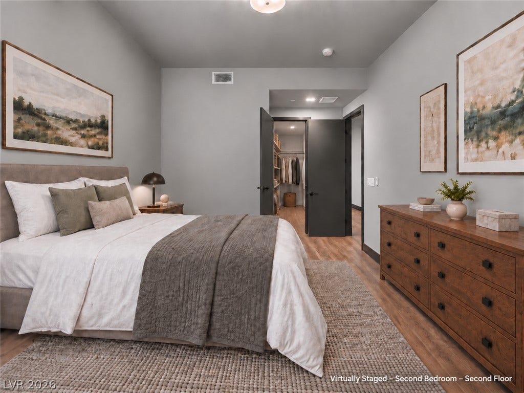 Gleaming wood floors anchor this comfortable bedroom complete with a generous walk-in closet.