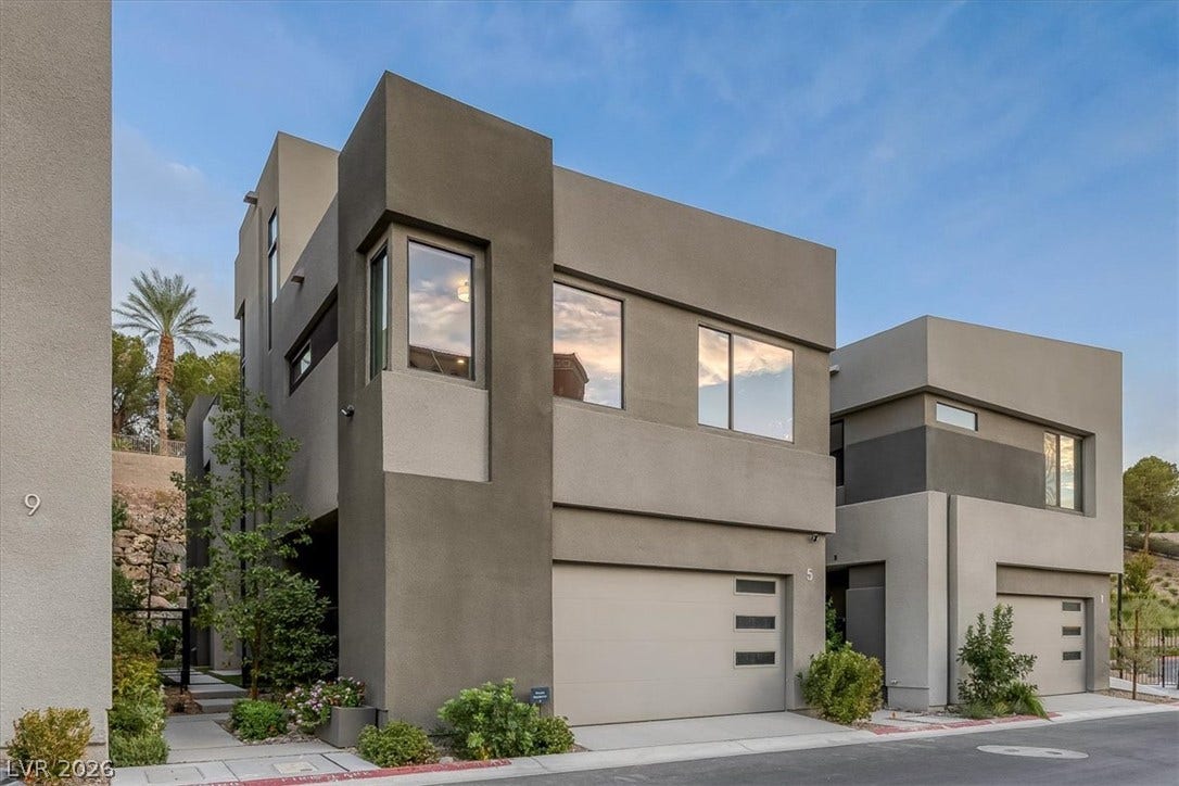 Striking contemporary lines define this modern multi-level exterior boasting expansive glass windows and sleek stucco finishes.
