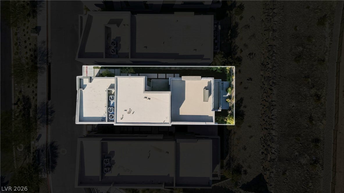 Bird's-eye view reveals the clean architectural lines and flat-roof design of this modern home.