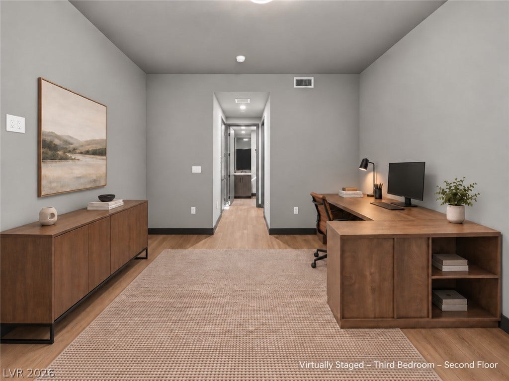 Warm wood flooring and clean architectural lines define this versatile second-floor space.