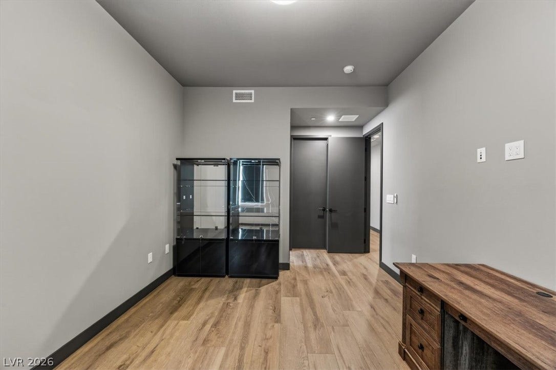 Rich wood-look flooring and clean lines define this versatile modern office space.