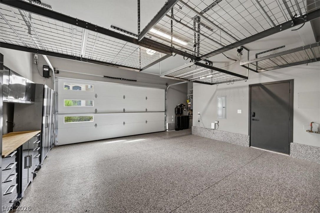 Durable epoxy flooring and extensive overhead storage racks maximize utility in this double garage.