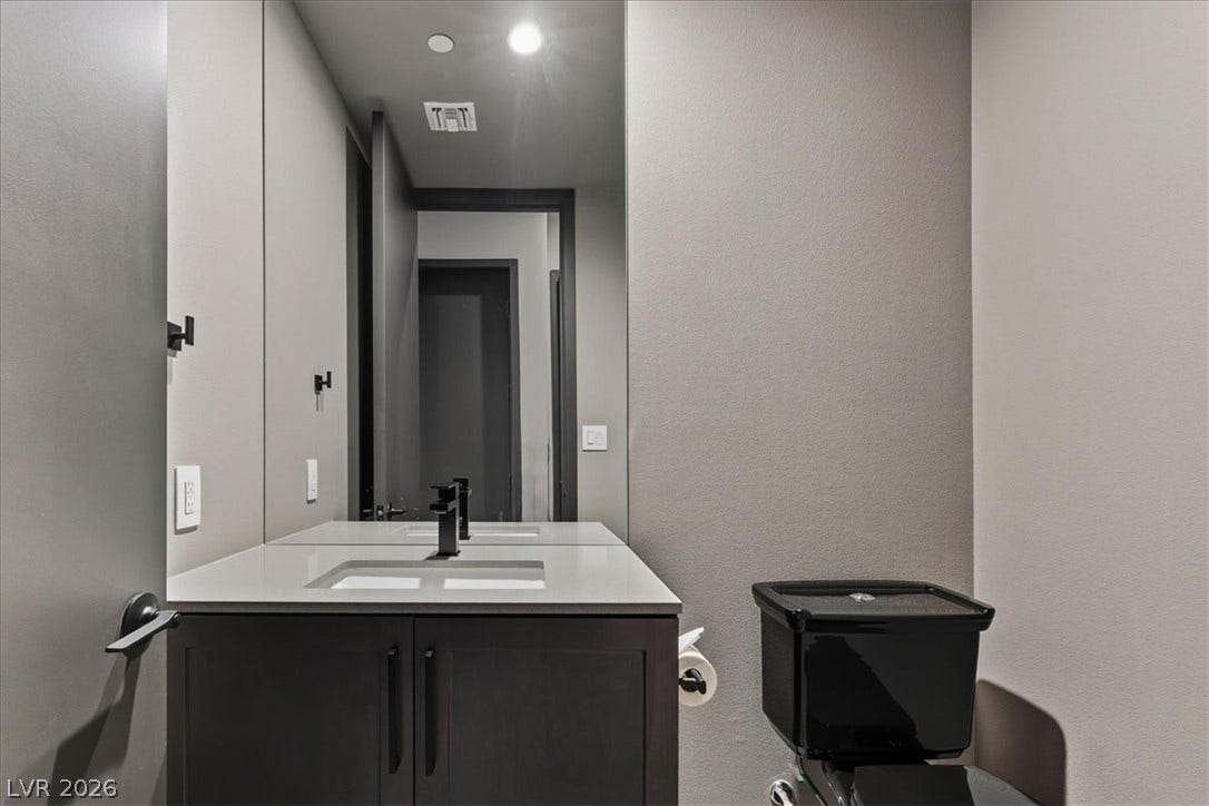 Clean lines and a modern vanity define this minimalist powder room.