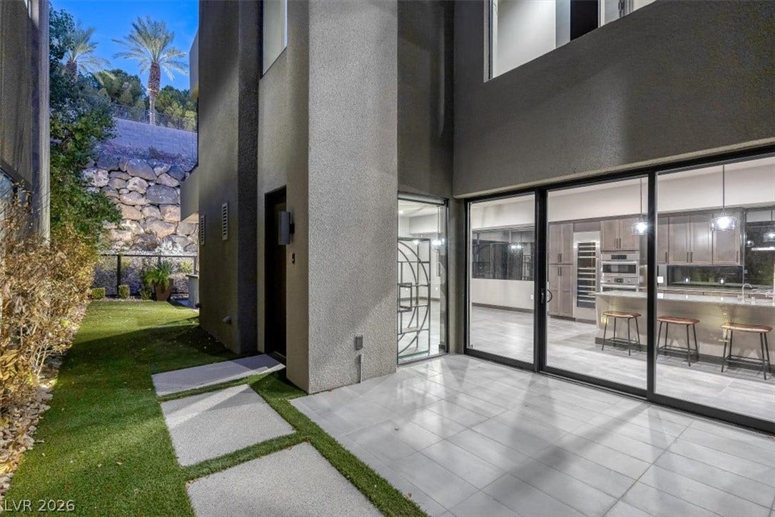 Sliding glass walls open this modern courtyard patio to the kitchen and main living areas.