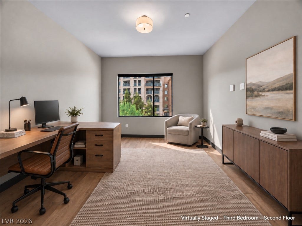 Smooth wood floors and a wide window frame views of the surrounding neighborhood.