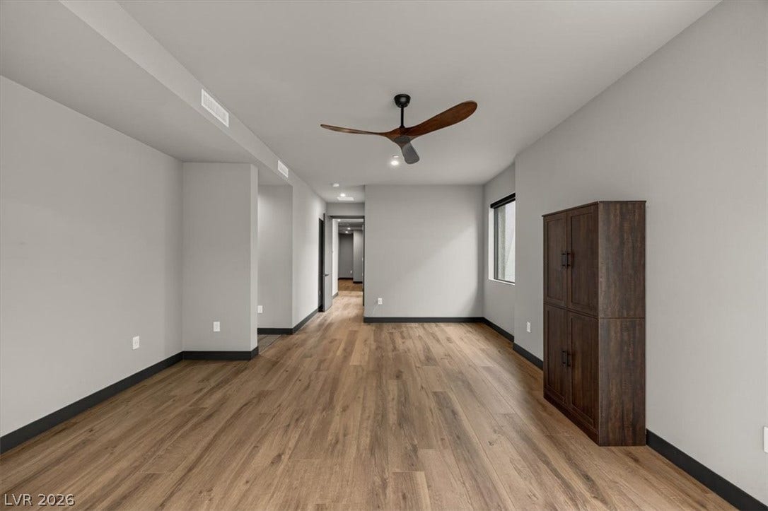 Rich wood-look flooring and clean lines define this versatile open interior space.