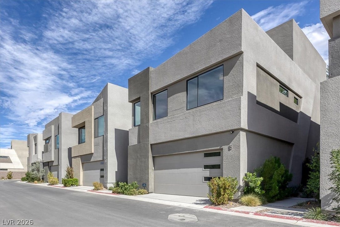 Striking contemporary architecture defines this multi-level exterior displaying crisp geometric lines.