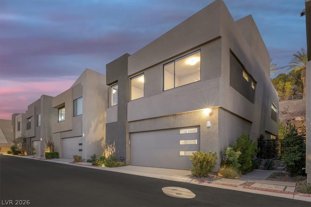 Bold geometric lines and modern finishes define this striking contemporary townhome facade.