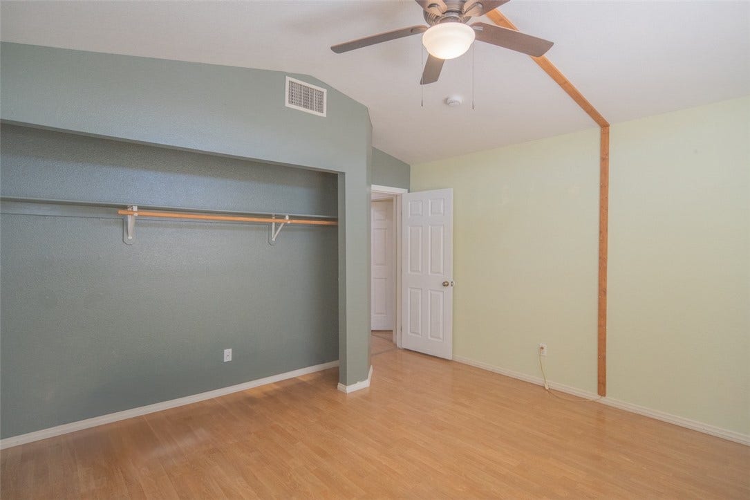 121 Heather Drive, Henderson, NV 89002 Warm laminate flooring pairs with vaulted ceilings in this versatile bedroom space.