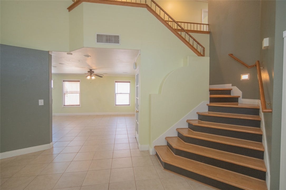 121 Heather Drive, Henderson, NV 89002 An inviting entryway transitions smoothly into a tiled living space with clean lines and architectural stairways.