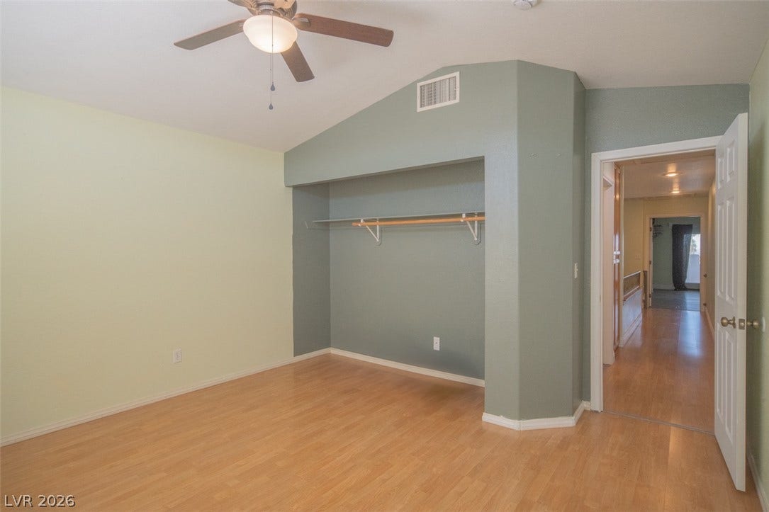121 Heather Drive, Henderson, NV 89002 Gleaming hardwood floors and a vaulted ceiling elevate this versatile bedroom space.