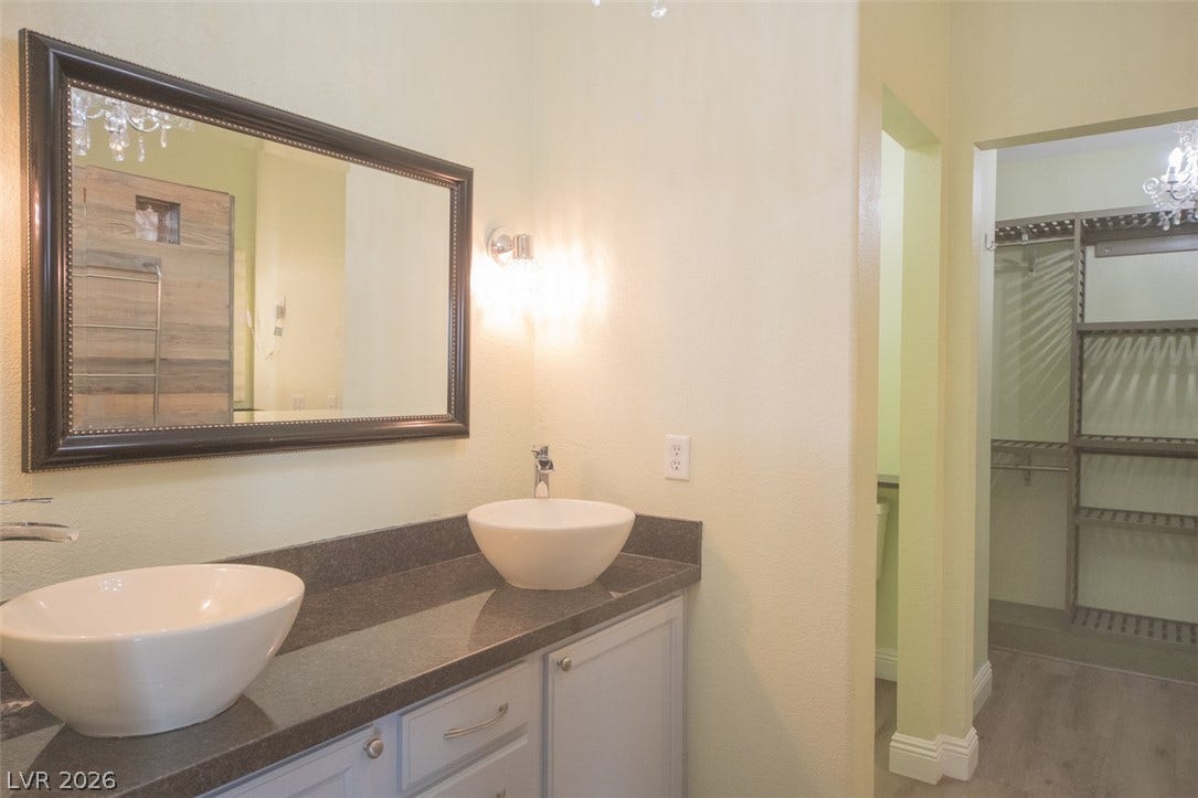121 Heather Drive, Henderson, NV 89002 A spacious double vanity vanity area transitions smoothly into an adjacent walk-in closet.