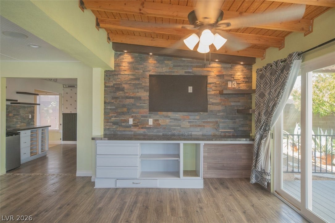 121 Heather Drive, Henderson, NV 89002 Rich wood plank ceilings and a rugged stone accent wall define this open living space.