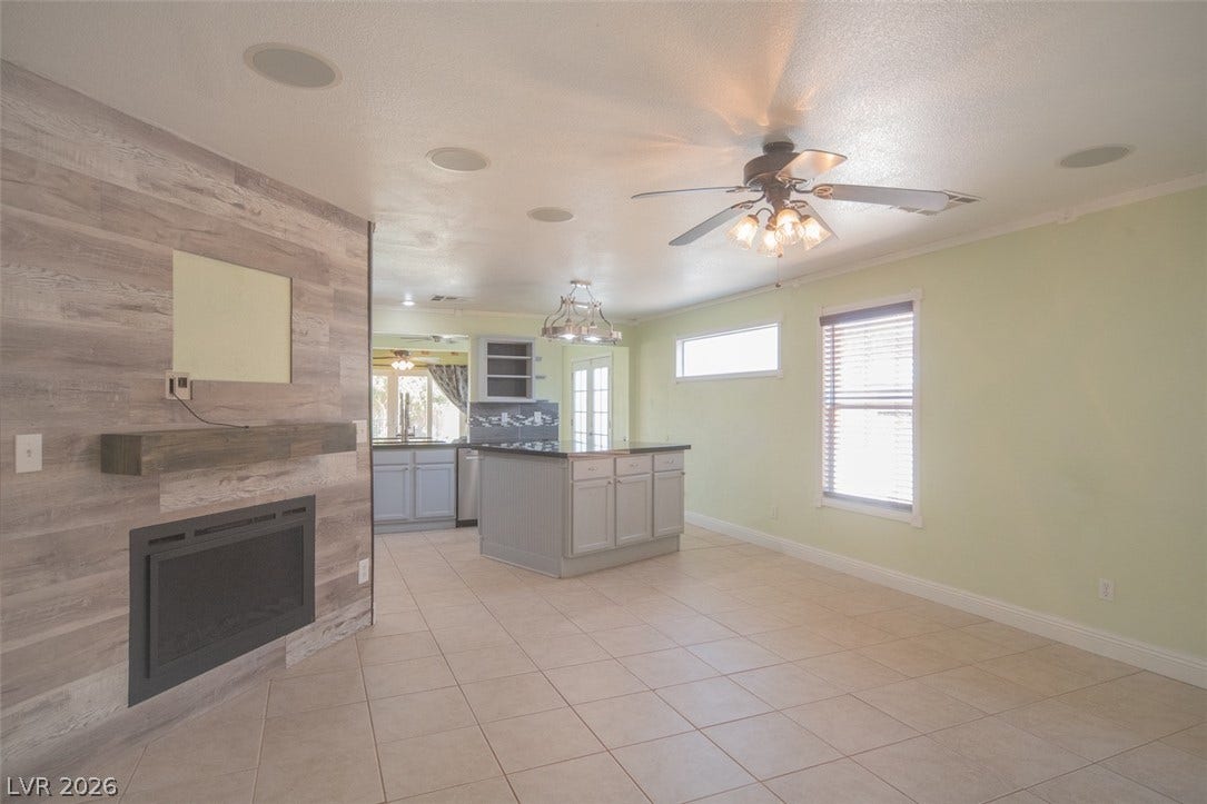 121 Heather Drive, Henderson, NV 89002 An open floor plan seamlessly connects the tiled living space to a modern kitchen.