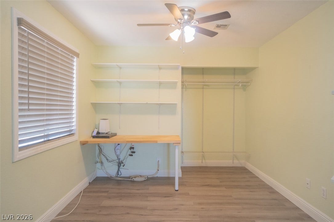 121 Heather Drive, Henderson, NV 89002 Adjustable shelving and a built-in desk highlight this versatile room with wood-style flooring.