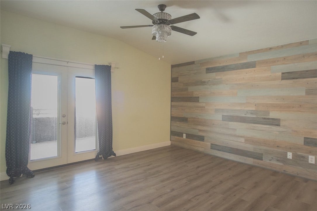 121 Heather Drive, Henderson, NV 89002 An accent wall highlights this space featuring clean flooring and glass doors to the outside.