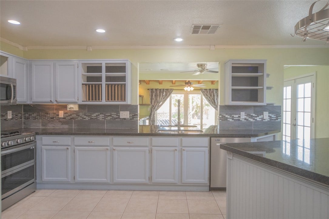 121 Heather Drive, Henderson, NV 89002 Ample counter space and classic cabinetry define this functional kitchen workspace.