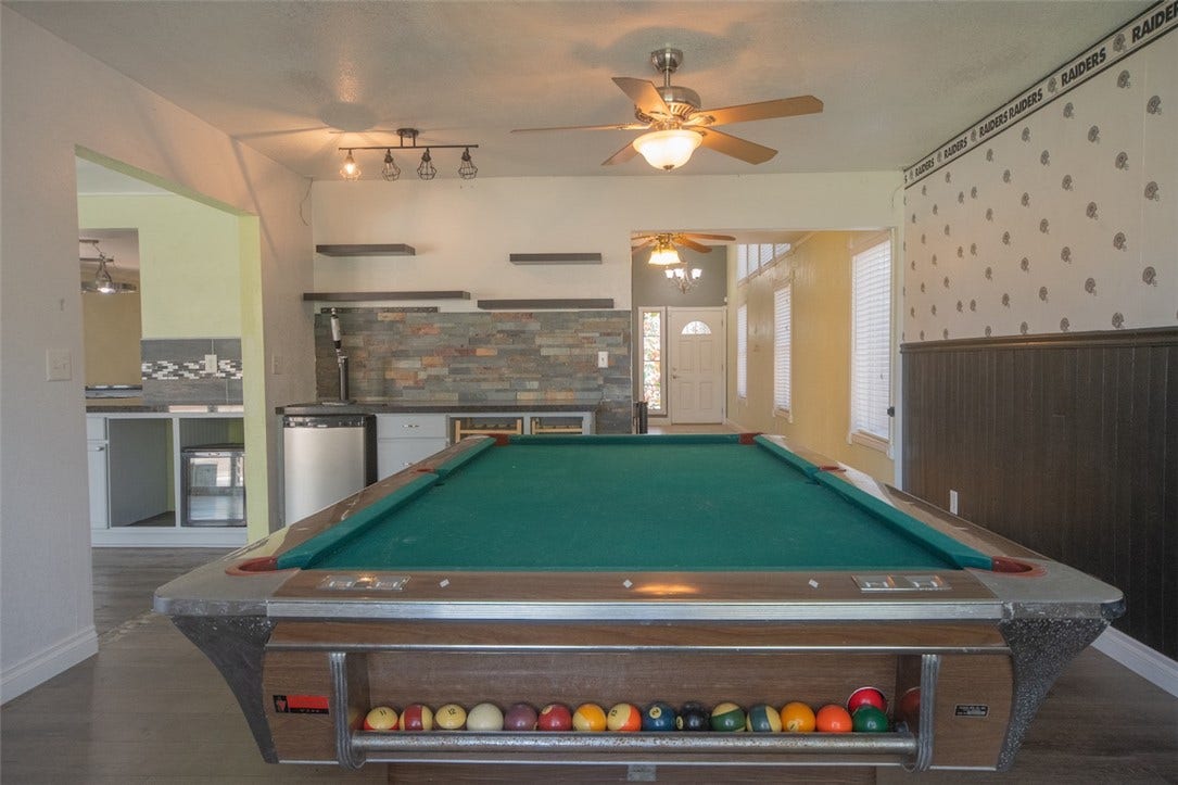 121 Heather Drive, Henderson, NV 89002 An open recreation space features durable flooring and a built-in wet bar setup.
