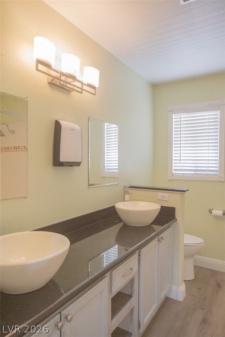 121 Heather Drive, Henderson, NV 89002 A modern vanity with dual vessel sinks pairs elegantly with polished stone countertops.