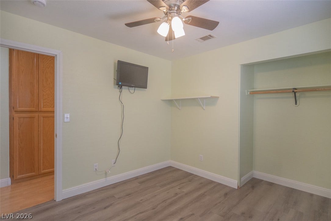 121 Heather Drive, Henderson, NV 89002 Gleaming wood-inspired floors and clean baseboards define this versatile secondary bedroom space.