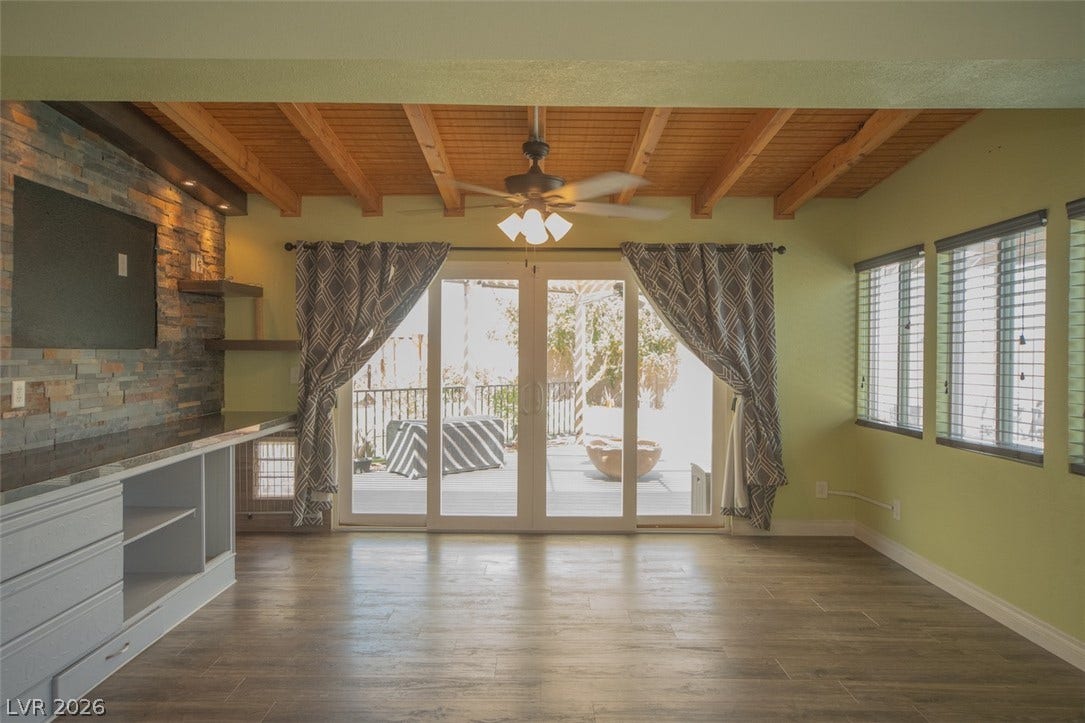 121 Heather Drive, Henderson, NV 89002 Exposed wood beams and stone wall details highlight this open living area.