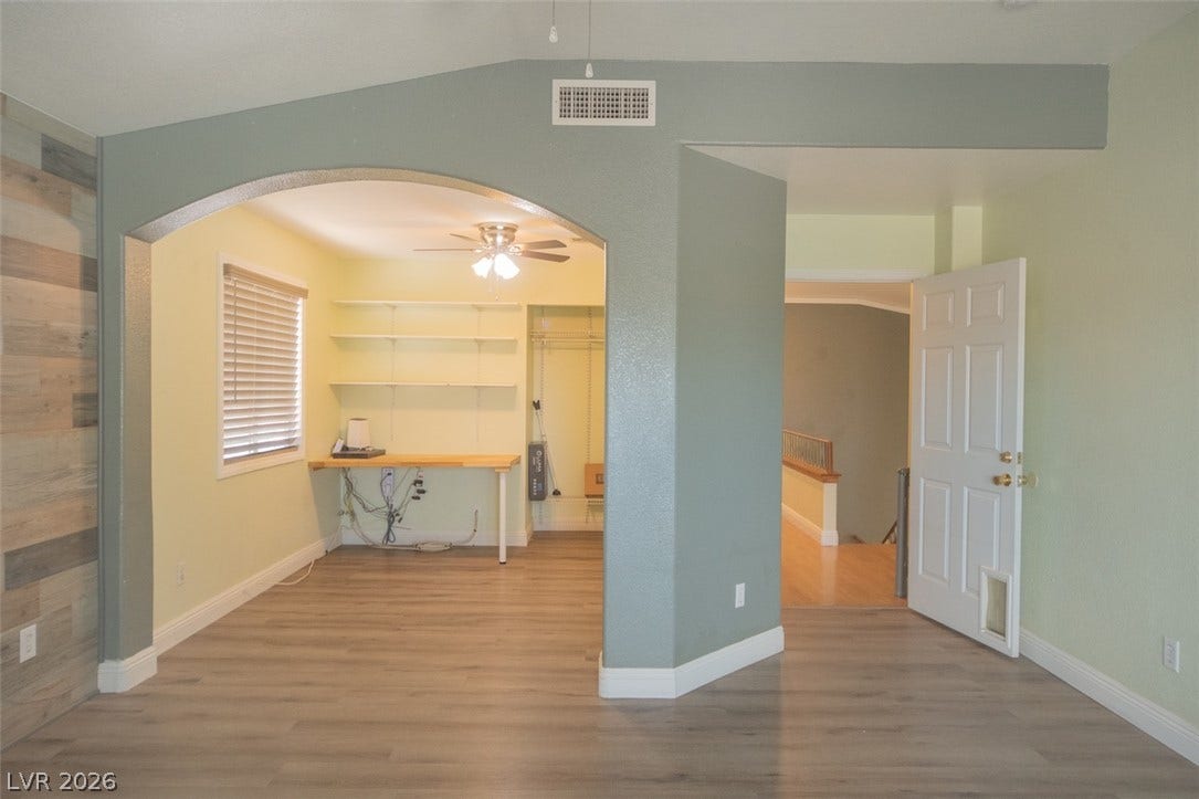 121 Heather Drive, Henderson, NV 89002 An arched doorway leads to a versatile home office nook with durable wood-look flooring.