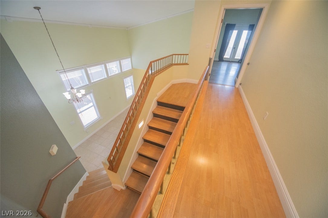 121 Heather Drive, Henderson, NV 89002 An airy upper hallway overlooks the lower level, connected by warm wood stairs.