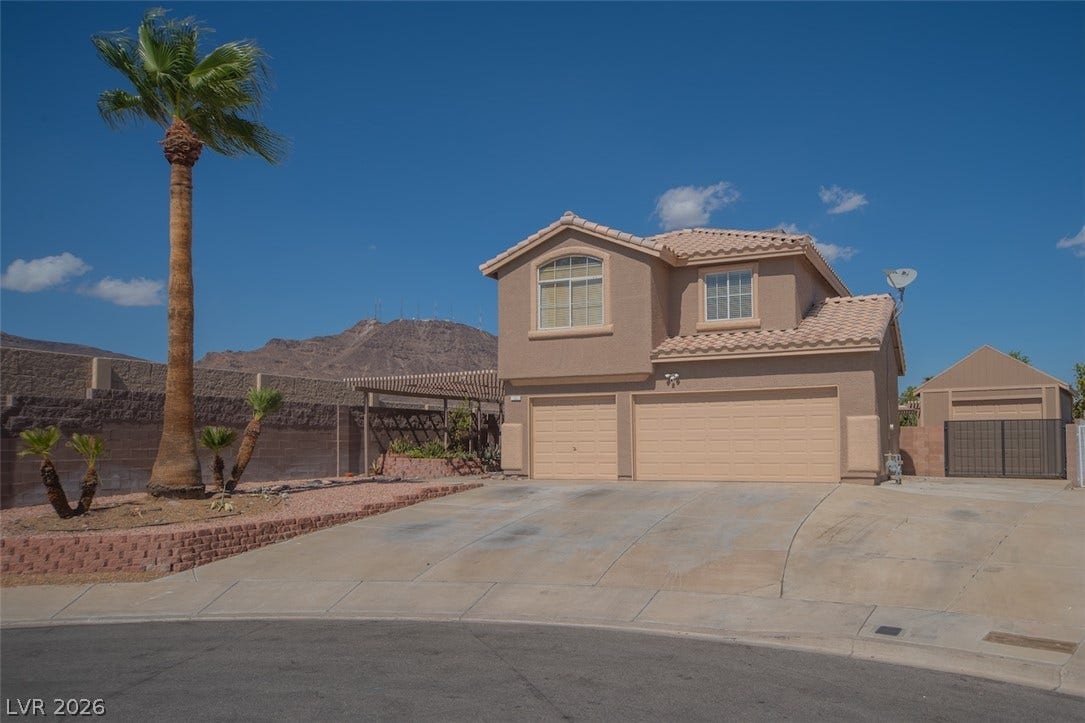 121 Heather Drive, Henderson, NV 89002 Sought-after desert setting frames this multi-level home featuring tile roofing and integrated garage parking.