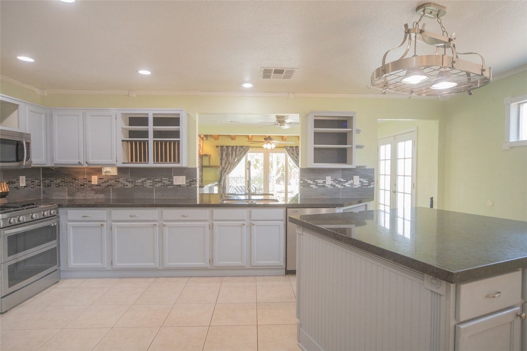 121 Heather Drive, Henderson, NV 89002 Polished stone countertops complement tiled floors in this spacious, well-lit cooking area.