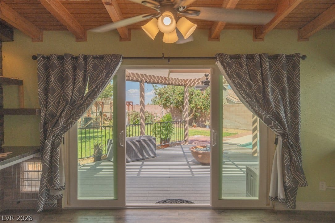 121 Heather Drive, Henderson, NV 89002 Sliding glass doors open from the beamed-ceiling living area directly onto the private backyard deck.