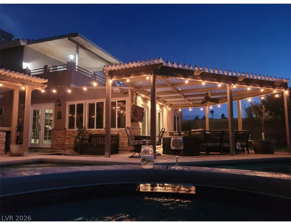 121 Heather Drive, Henderson, NV 89002 An inviting backyard oasis features a spacious pergola-covered patio adjacent to the sparkling pool.