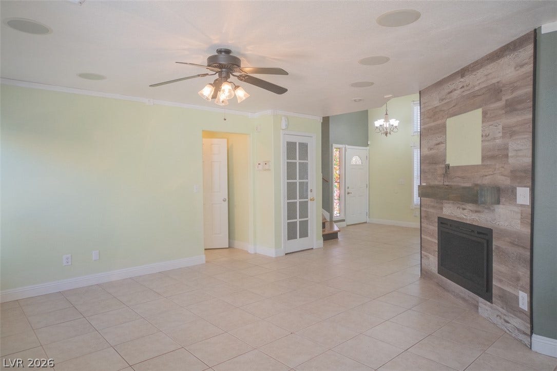 121 Heather Drive, Henderson, NV 89002 An inviting open floor plan connects the tiled living space with a warm fireplace.