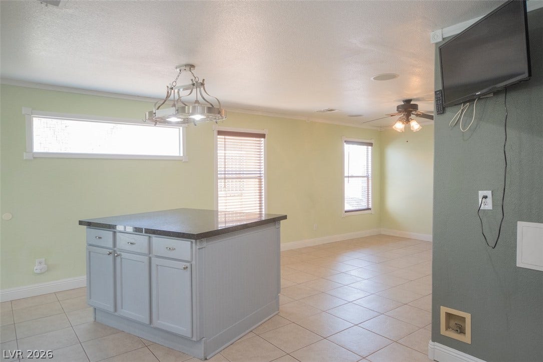 121 Heather Drive, Henderson, NV 89002 An open floorplan connects the central preparation island with the adjoining living area.